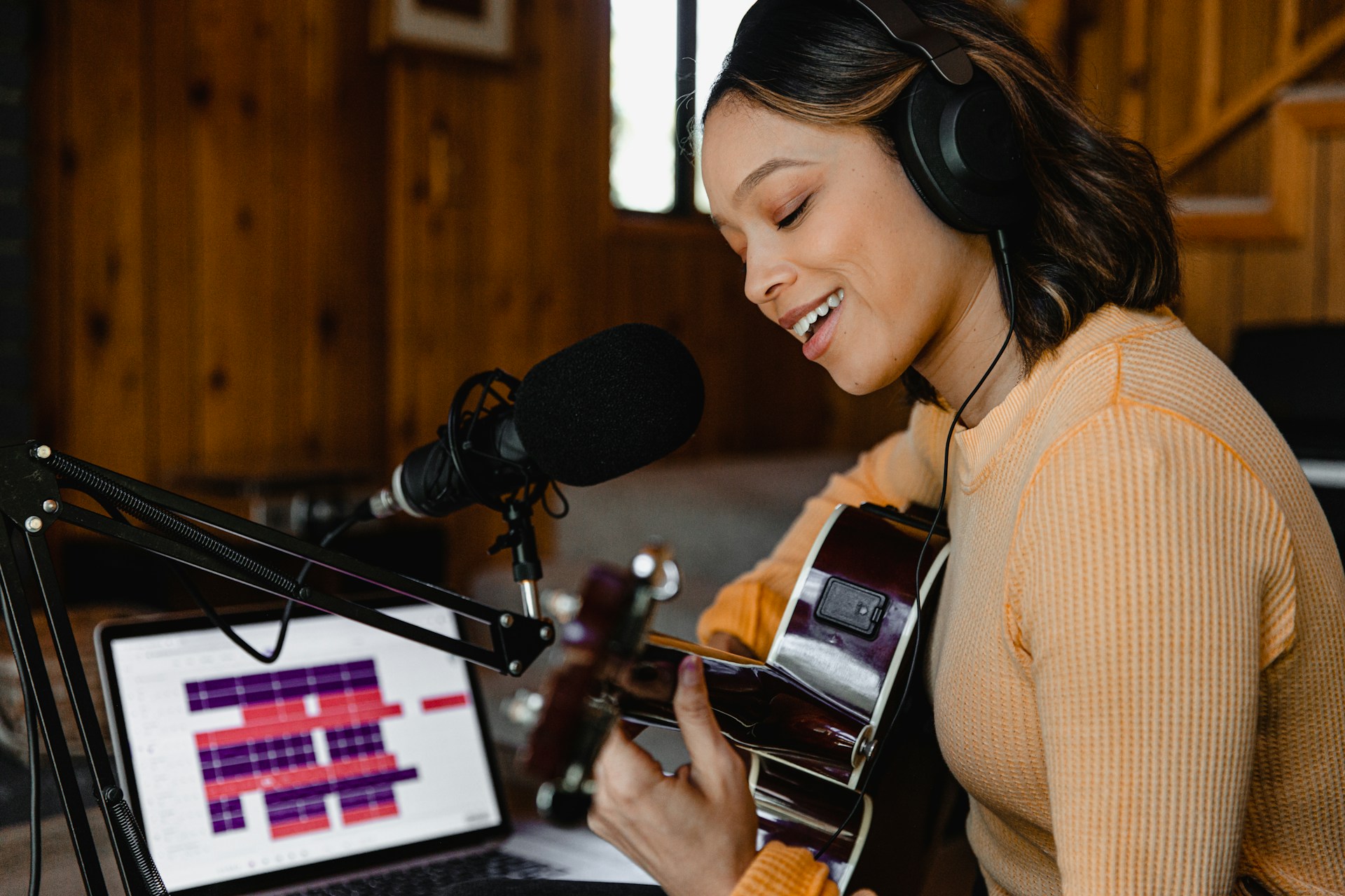 Woman recording guitar